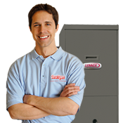 Heating Repairs A technician standing with arms folded in front of a furnace