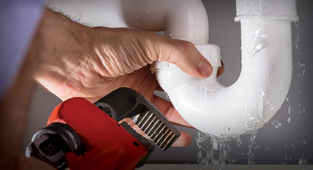 AC and Heating Plumber fixing a leaky pipe in a Raleigh, NC home